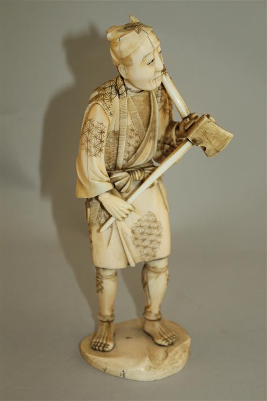 A Japanese sectional ivory figure of a woodsman, early 20th century, 24.5cm